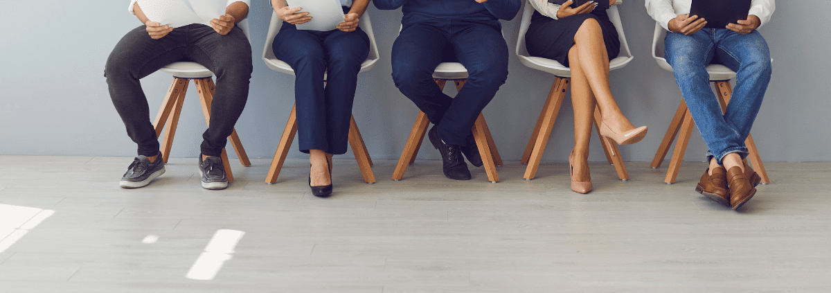 people sitting on a chair holding a paper